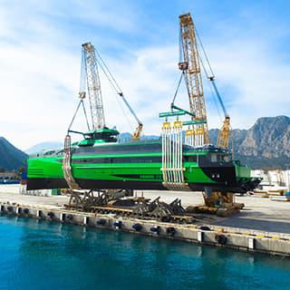 Two Demag® CC 2800-1 crawler cranes bring 410-tonne ship to water